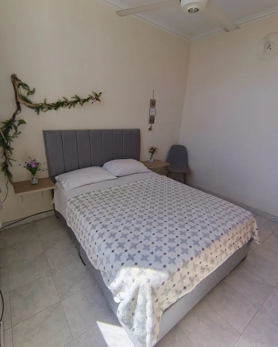 Bedroom with a double bed and morning light